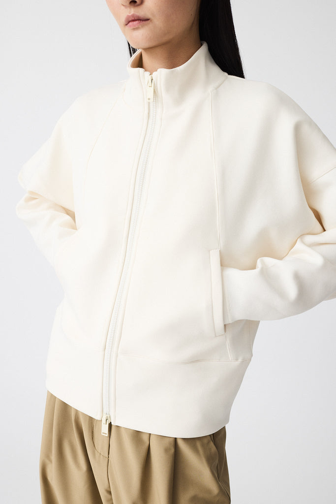 Sudadera de Mujer Tantä con cremallera en tejido interlock secado rápido. Color Blanco roto 