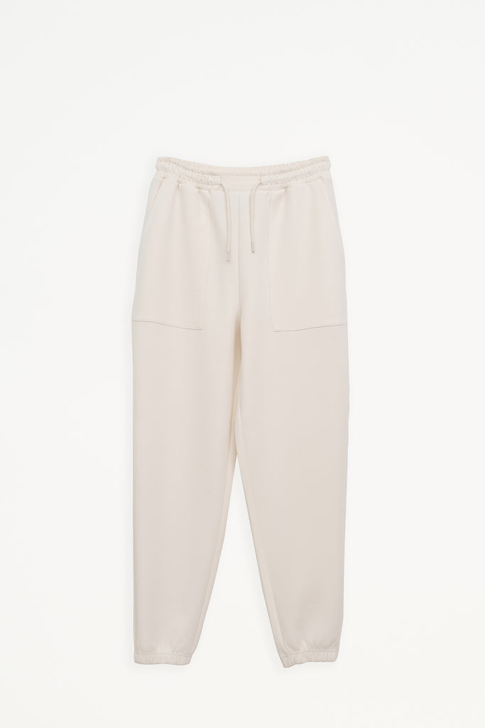 Pantalón jogger confeccionado en tejido interlock de mujer Tantä. Color blanco roto